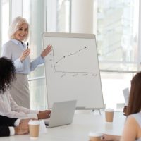 Experienced,Positive,Business,Woman,Presenting,To,Company,Staff,Report,,Showing