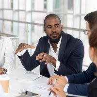 Millennial,Employees,Gathered,In,Boardroom,For,Training,,Black,Boss,Ceo