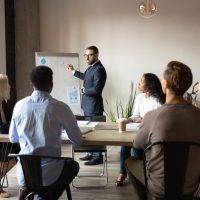 Serious,Businessman,Training,Speaker,Coach,Wear,Suit,Give,Presentation,At